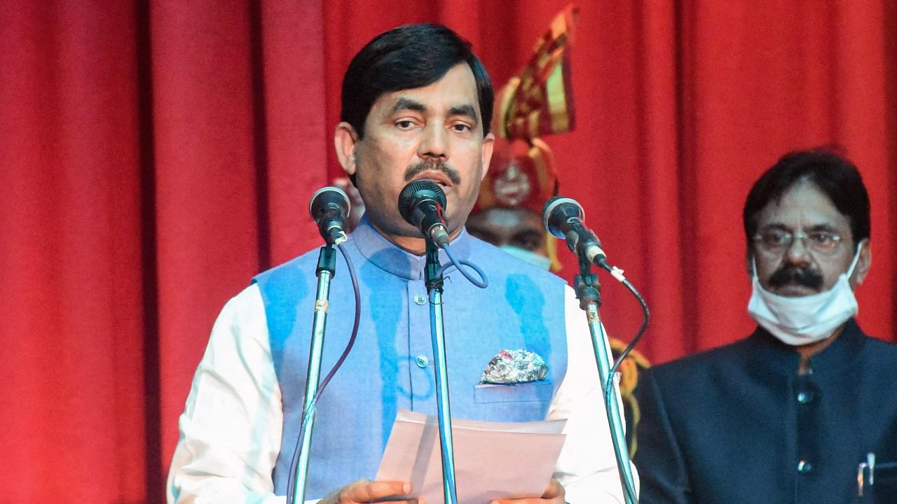 Syed Shahnawaz Hussain takes the oath of office during the swearing-in ceremony for cabinet expansion of coalition government of NDA at Raj Bhawan, in Patna. Credit: PTI Photo.