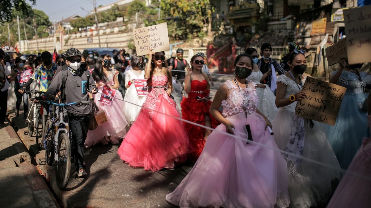 Women wearing ball gowns protest against the military coup. Credit: Reuters Photo.