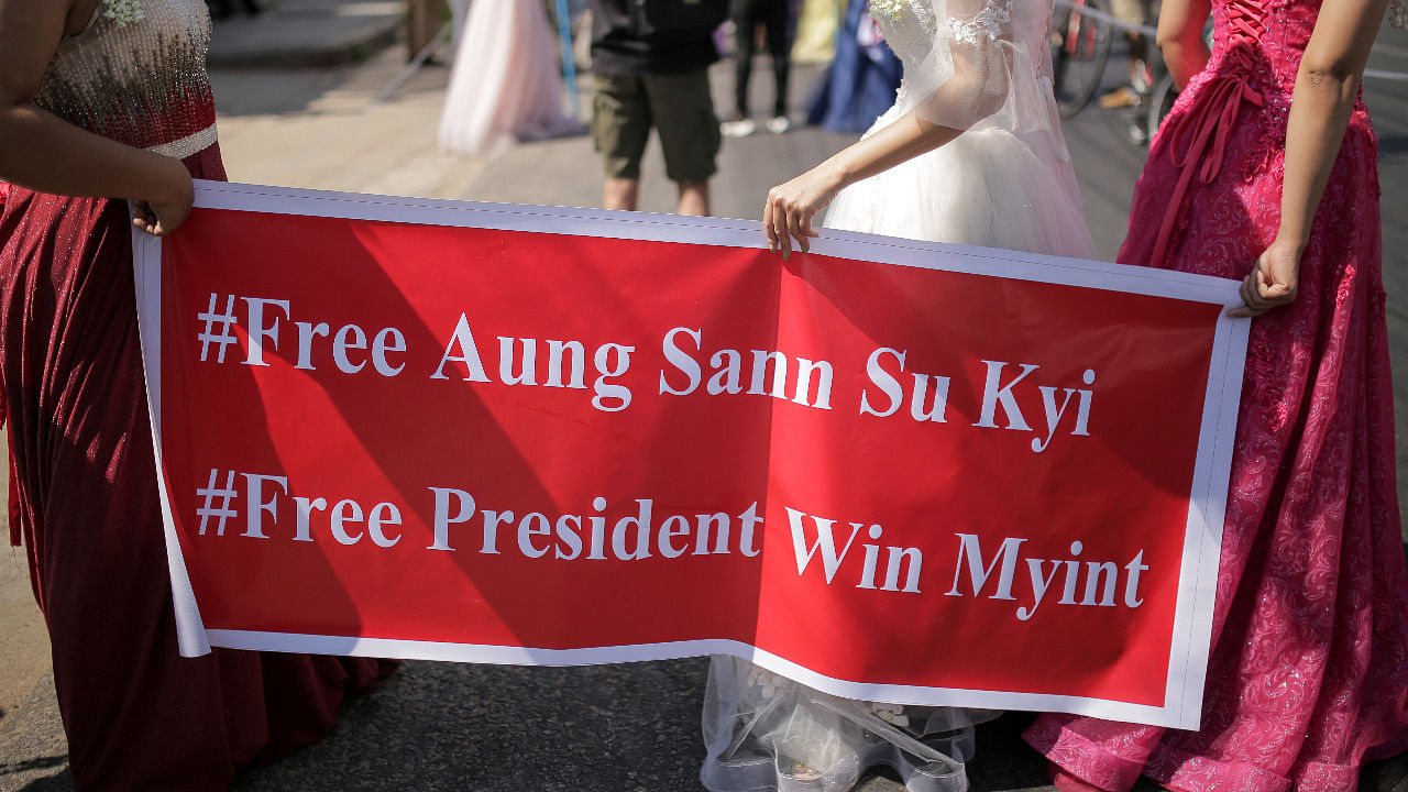 Women wearing ball gowns protest against the military coup and to demand the release of elected leader Aung San Suu Kyi in Yangon, Myanmar. Credit: Reuters Photo