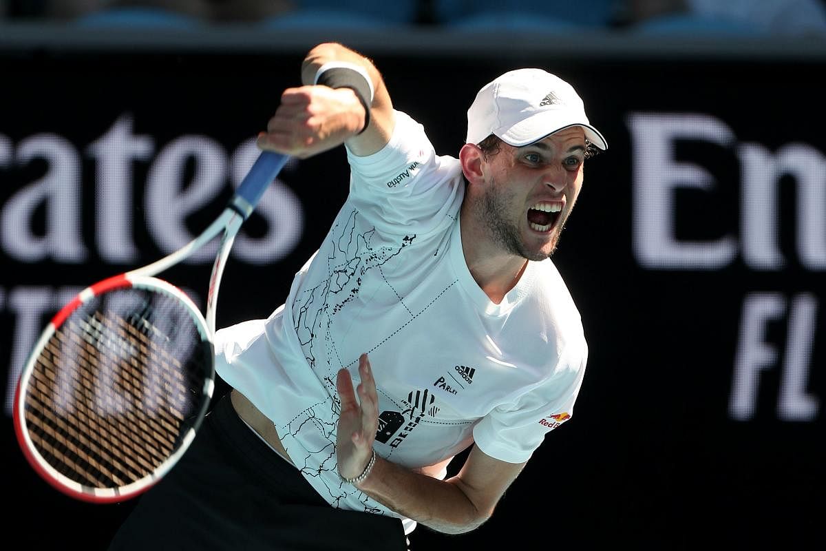 Austria's Dominic Thiem serves against Germany's Dominik Koepfer during their men's singles match on day three of the Australian Open tennis tournament in Melbourne. Credit: AFP Photo. 