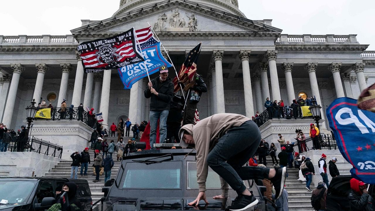 Impeachment prosecutors aired terrifying, never-before-seen footage of senior US politicians fleeing for their lives during the January assault on Congress by Donald Trump supporters on day two of the former president's Senate trial. Credit: AFP Photo