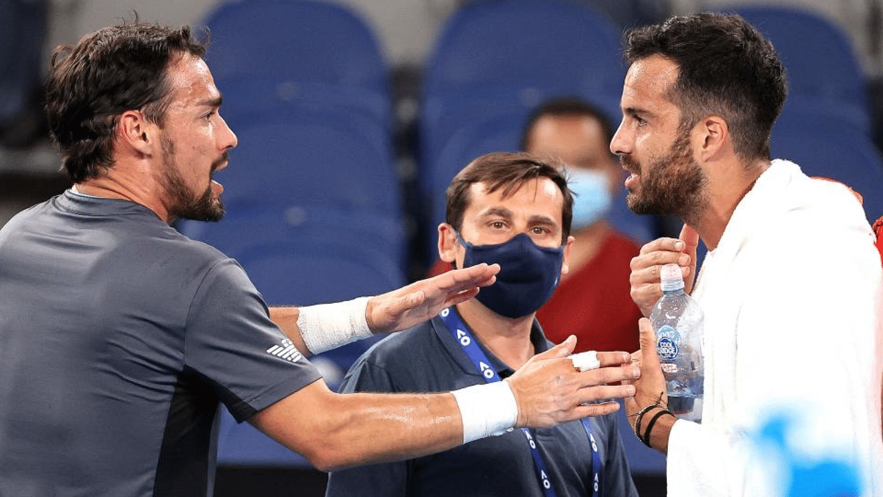 Italian player Salvatore Caruso (R) and Fabio Fognini argue after their men's singles match on day four of the Australian Open tennis tournament in Melbourne on February 11, 2021. Credit: AFP Photo