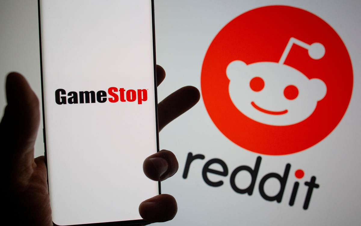  GameStop logo is seen in front of displayed Reddit logo. Credit: Reuters photo. 
