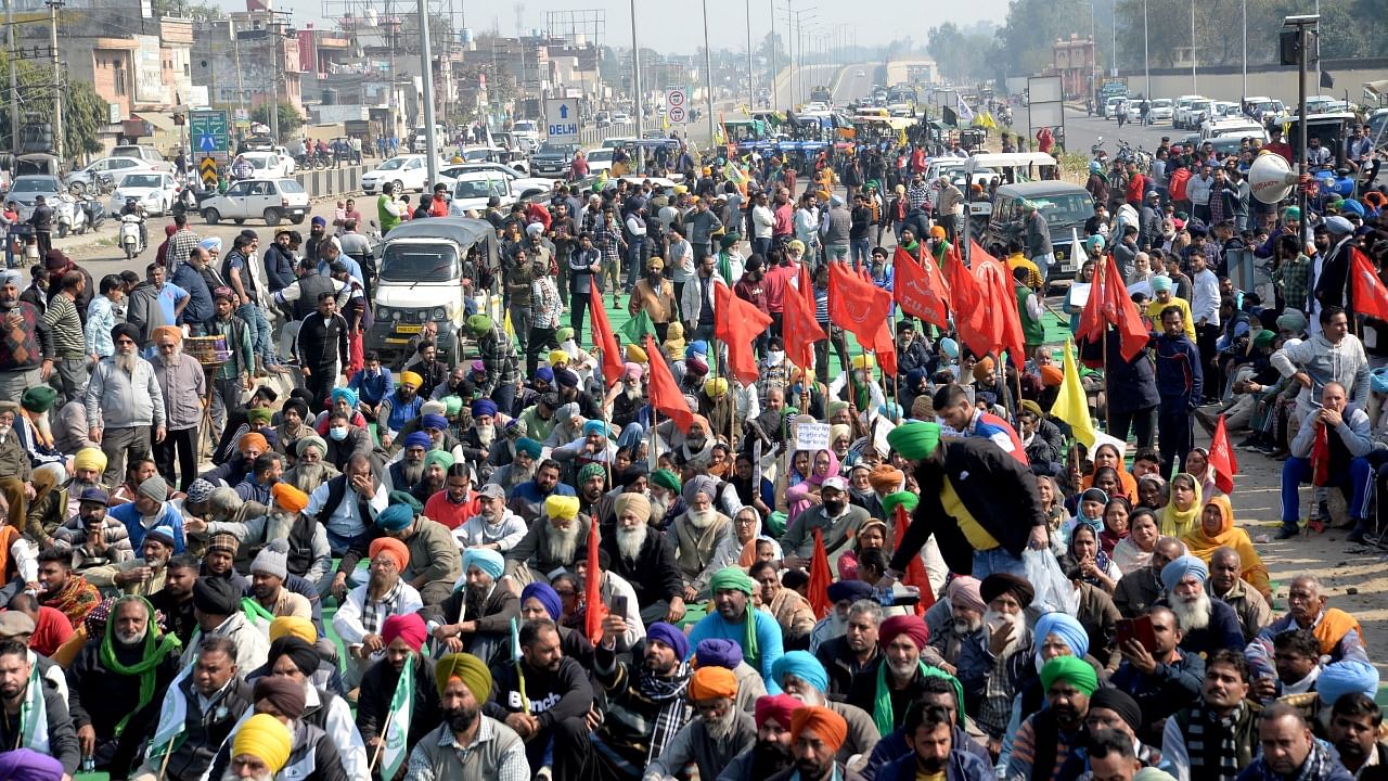 Farmers block Jalandhar-New Delhi National Highway during their 'chakka jam' protest as part of the ongoing agitation over new farm laws, in Jalandhar. Credit: PTI Photo