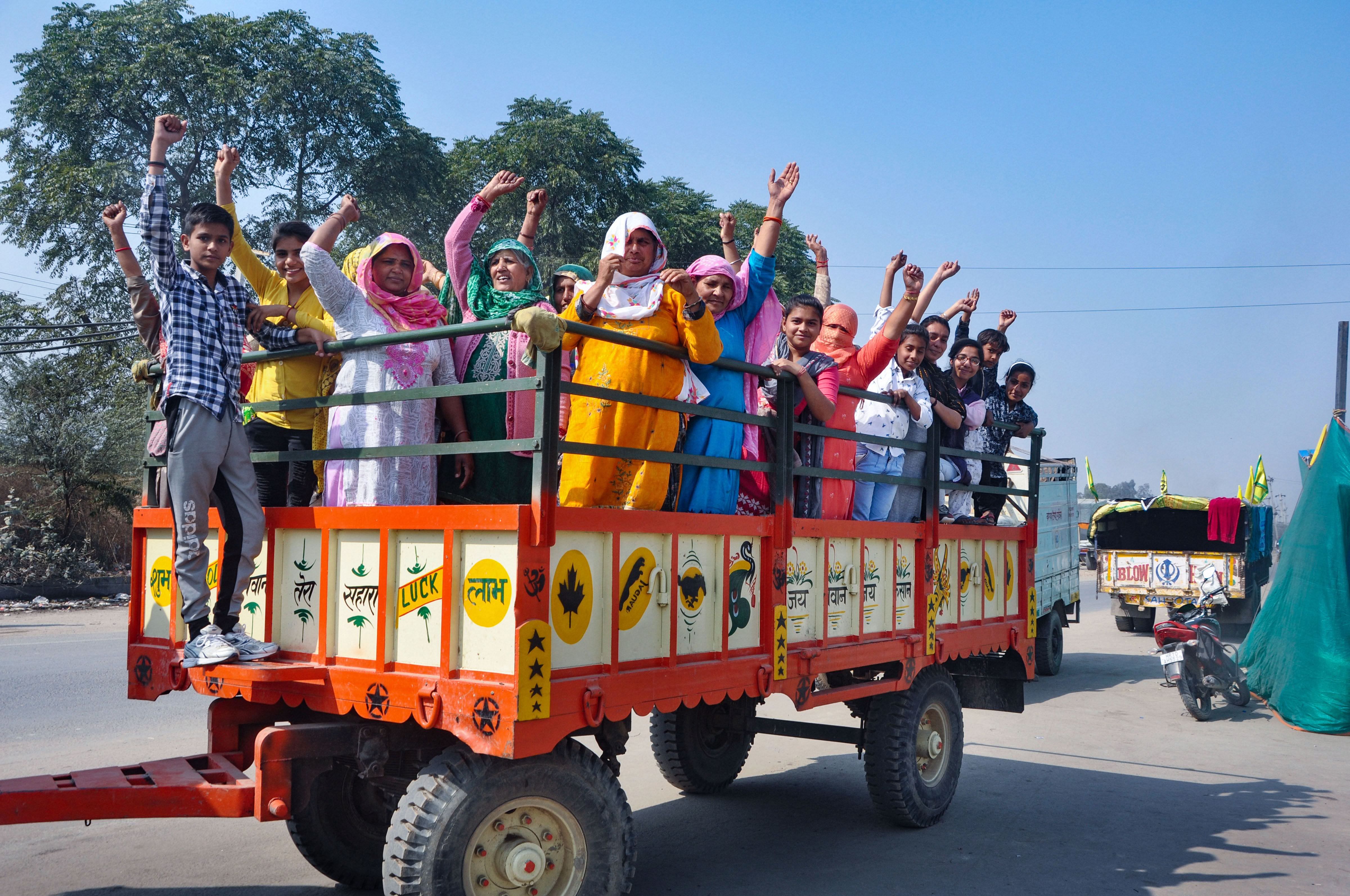 Women and children ride a tractor on their way to take part in farmers' protest against farm reform laws at Singhu border, in Sonipat district, Wednesday, Feb. 10, 2021. Credit: PTI Photo