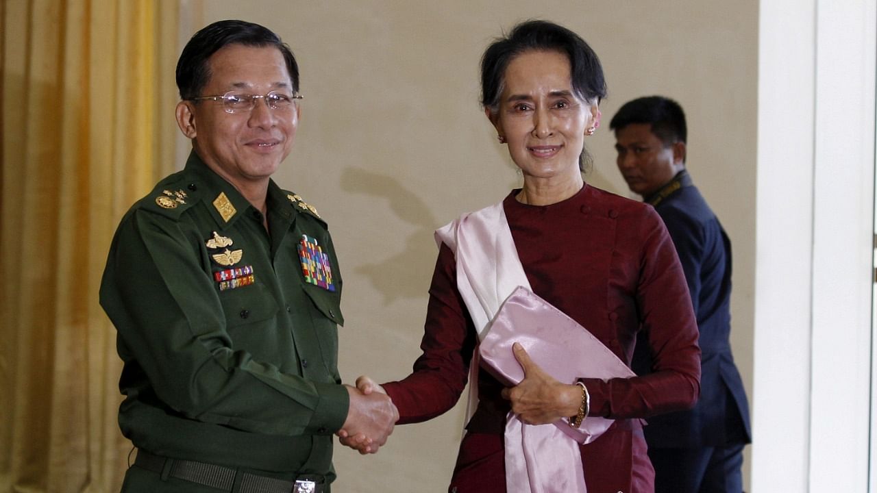 Senior General Min Aung Hlaing, Myanmar's commander-in-chief, shakes hands with National League for Democracy (NLD) party leader Aung San Suu Kyi. Credit: Reuters Photo