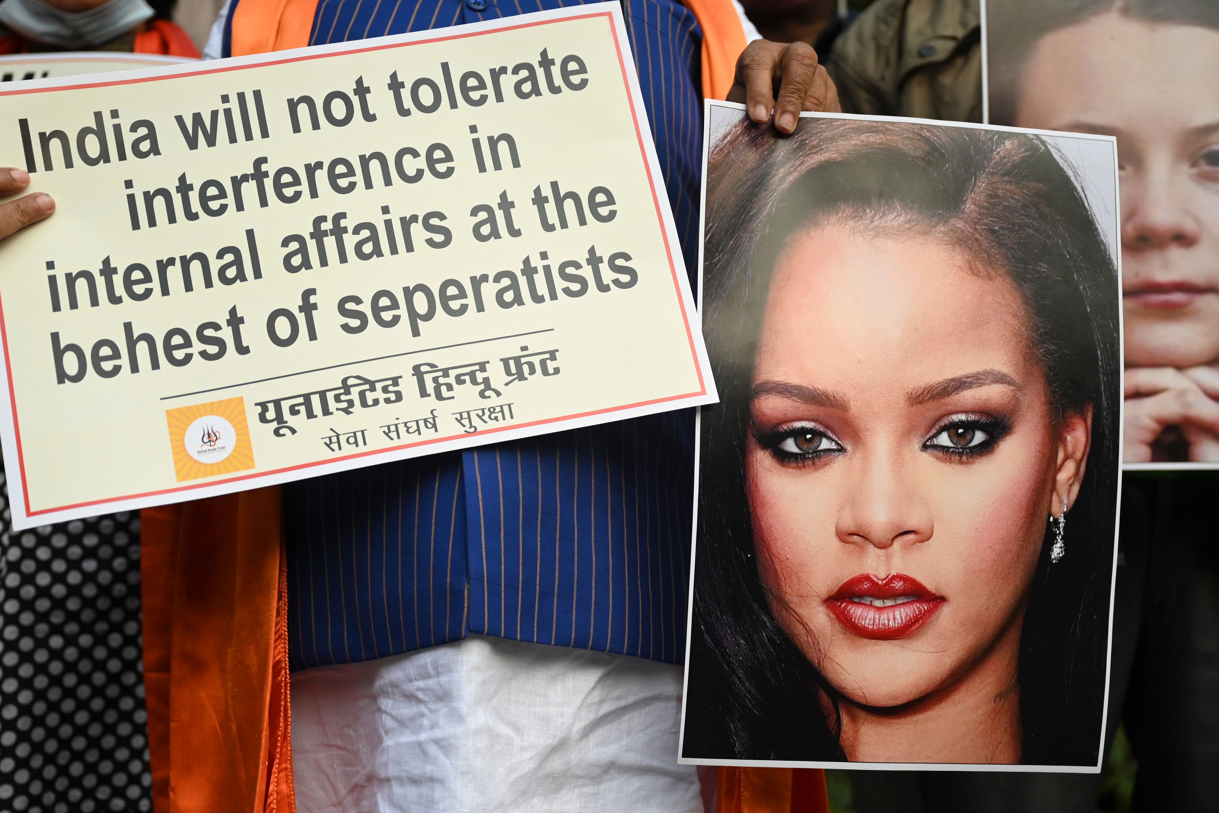 Activists of United Hindu Front (UHF) hold a placard and pictures of Swedish climate activist Greta Thunberg and Barbadian singer Rihanna. Credit: AFP Photo