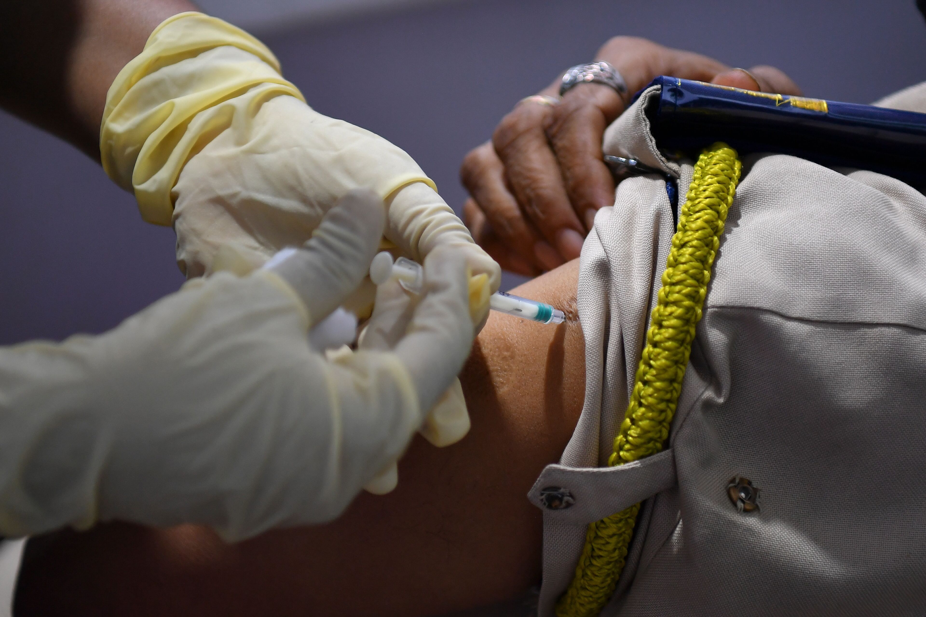 A medical staff inoculates a police personnel with a Covid-19 coronavirus vaccine at a vaccination centre in Mumbai. Credit: AFP Photo