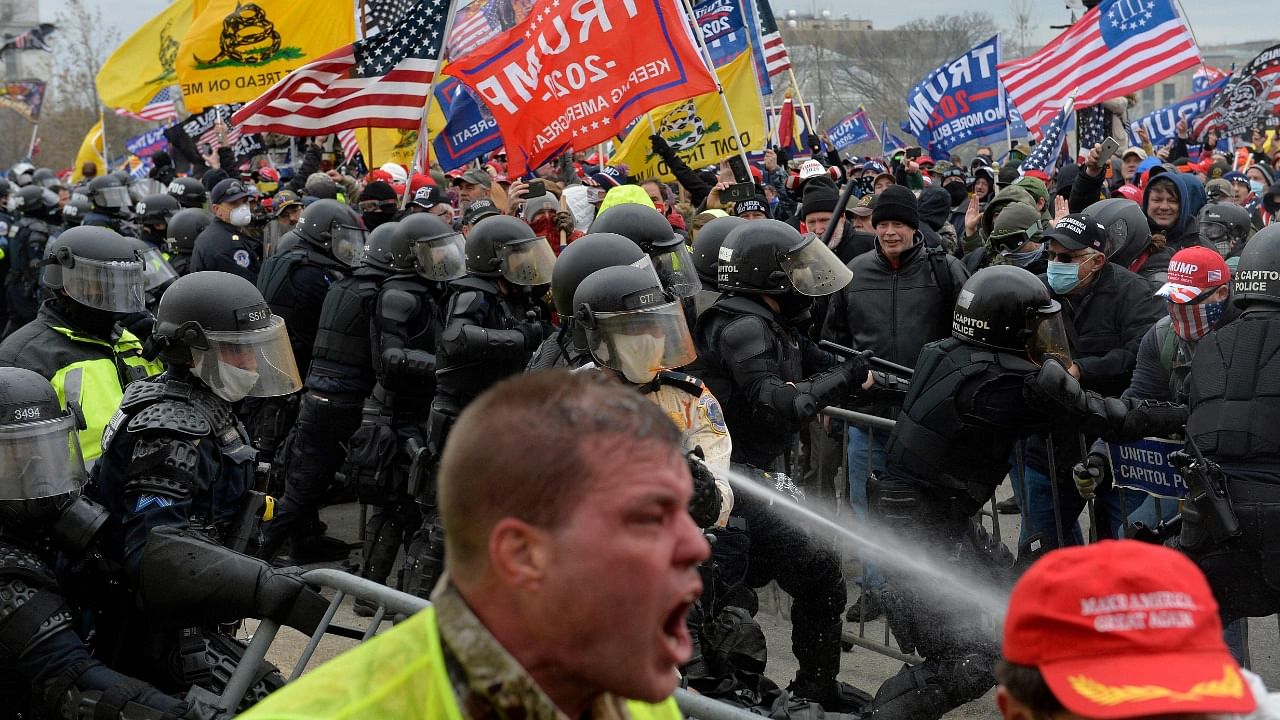In this file photo taken on January 6, 2021 Trump supporters clash with police and security forces as people try to storm the US Capitol in Washington DC. Credit: Reuters Photo