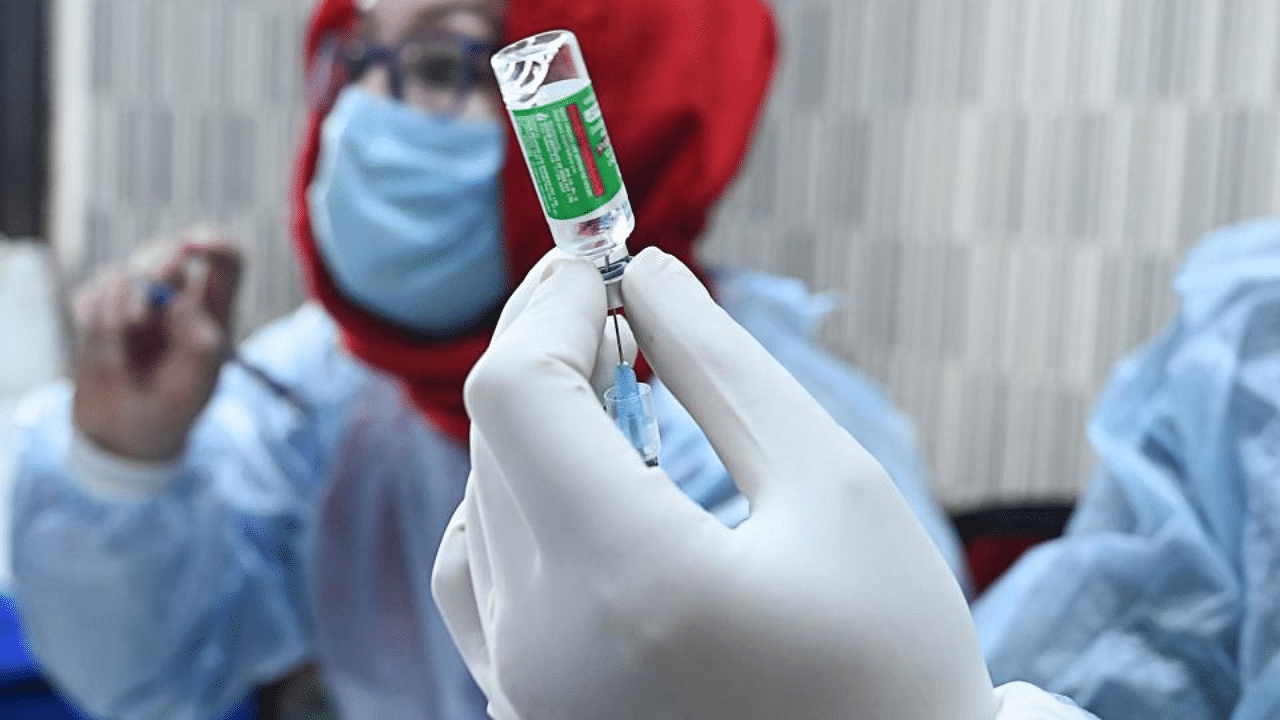 A medical worker prepares to inoculate a police personnel with a Covid-19 coronavirus vaccine at the Police headquarters in Srinagar on February 4, 2021. Credit: AFP Photo