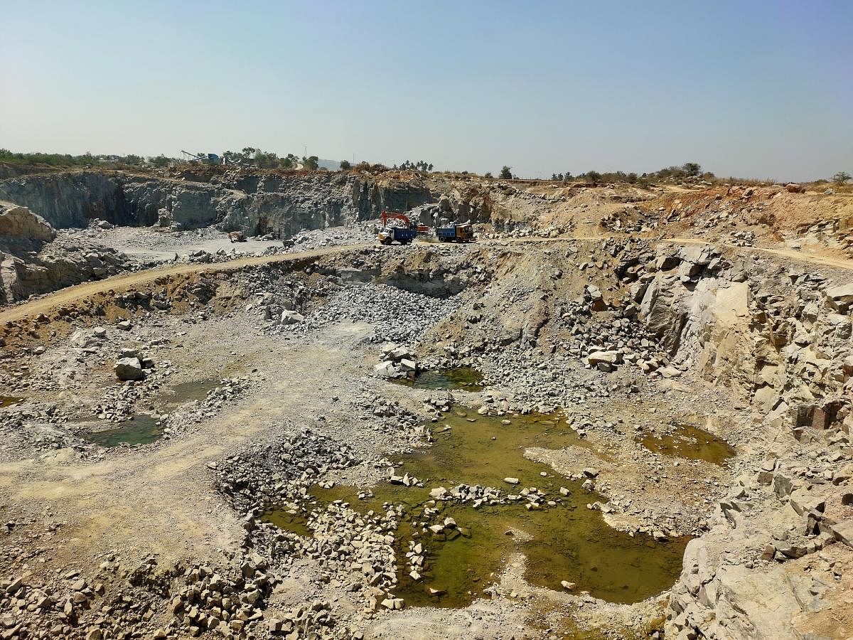 A portion of hill flattened due to indiscriminate stone quarrying at Parasapur village in Shirahatti taluk of Gadag district. Credit: DH Photo