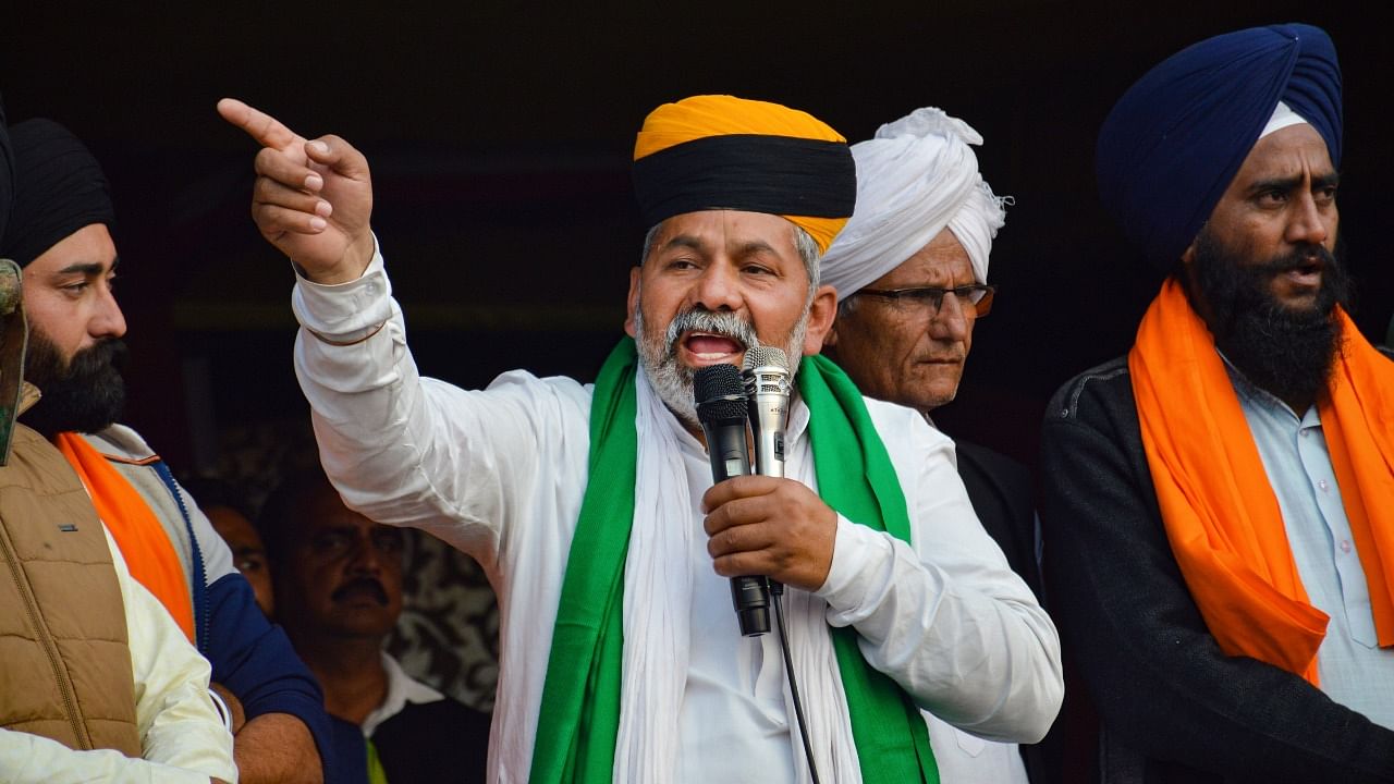 Bharatiya Kisan Union (BKU) spokesperson Rakesh Tikait addresses farmers during their ongoing agitation against Centre's farm reform laws, at Ghazipur border in New Delhi. Credit: PTI Photo