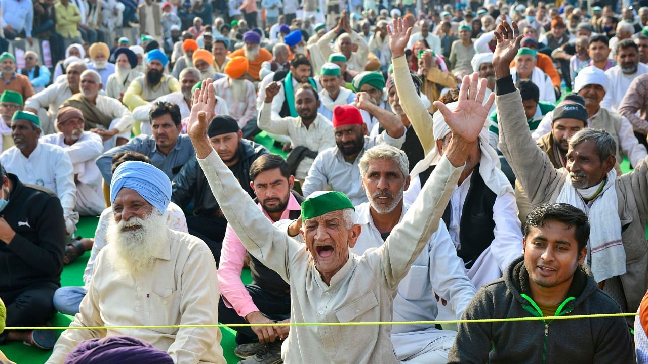 Farmers raise slogans during the ongoing protest against the new farm laws, at Ghazipur Border in New Delhi. Credit: PTI Photo