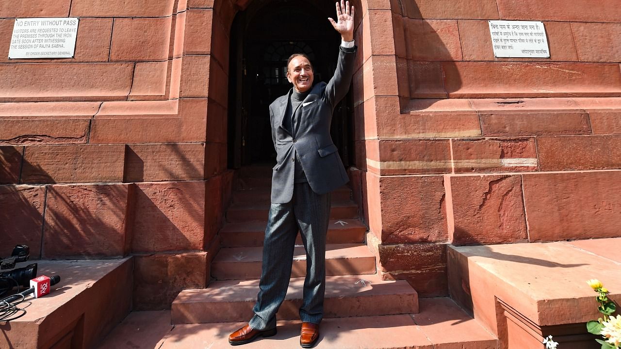 Senior Congress leader Ghulam Nabi Azad, who is retiring from the Rajya Sabha next week, waves at media during the ongoing Budget Session of Parliament, in New Delhi, Tuesday, February 9, 2021. Credit: PTI Photo