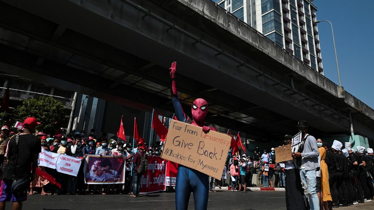 A protestor wearing a Spiderman costume gives the three-finger salute as he rallies against the military coup and to demand the release of elected leader Aung San Suu Kyi, in Yangon, Myanmar. Credit: Reuters Photo.