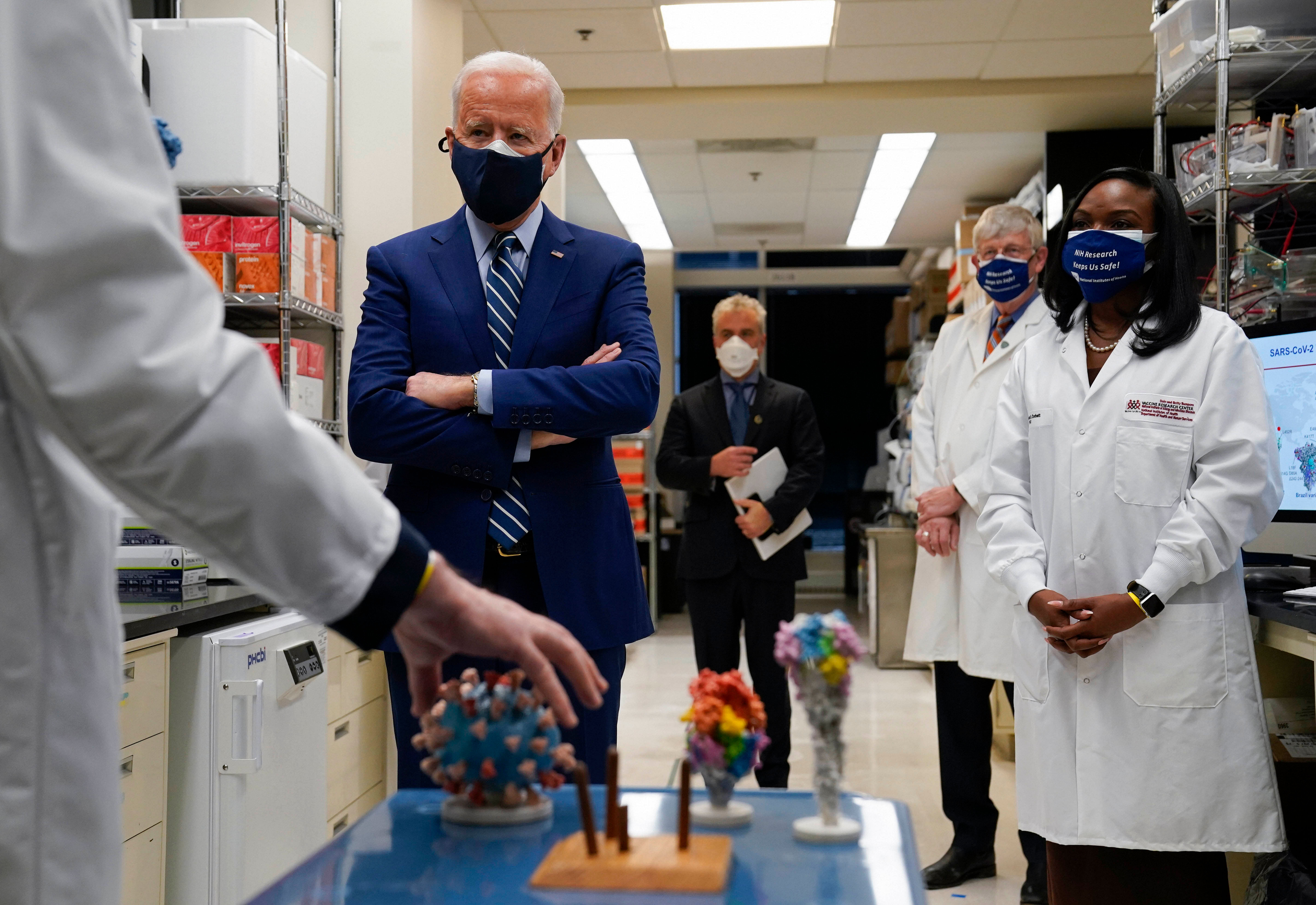 Bethesda: Dr. Barney Graham, left, speaks as President Joe Biden listens during a visit to the Viral Pathogenesis Laboratory at the National Institutes of Health (NIH), Thursday, Feb. 11, 2021, in Bethesda, Md. Francis Collins, Kizzmekia Corbett, an immunologist with the Vaccine Research Center at the NIH, right, and NIH Director, second from right, listen. Credit: AP/PTI