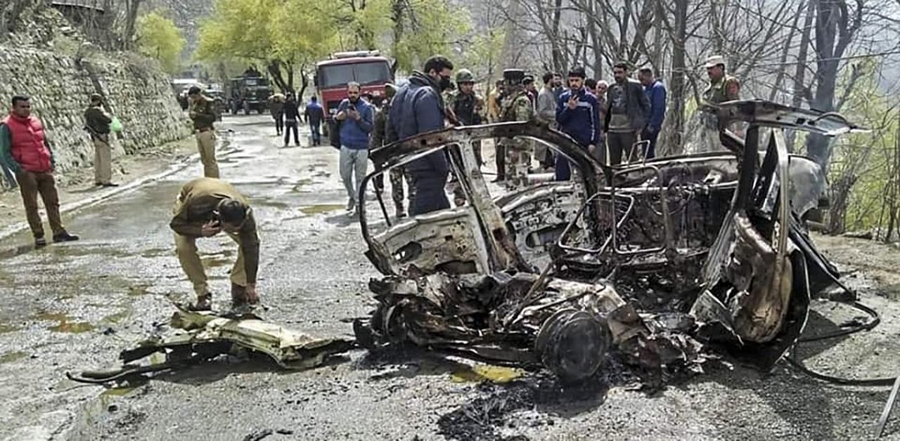 Security personnel inspect the mangled remains of a car which exploded near a CRPF convoy on the Jammu-Srinagar highway at Banihal, in Ramban district of Jammu and Kashmir, Saturday, March 30, 2019. Credit: PTI Photo