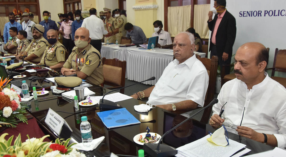 Chief Minister B S Yediyurappa, Home Minister Basavaraj Bommai and DG&amp;IGP Praveen Sood during a meeting with senior police officers at the Vidhana Soudha in Bengaluru on Friday. DH Photo/Janardhan B K
