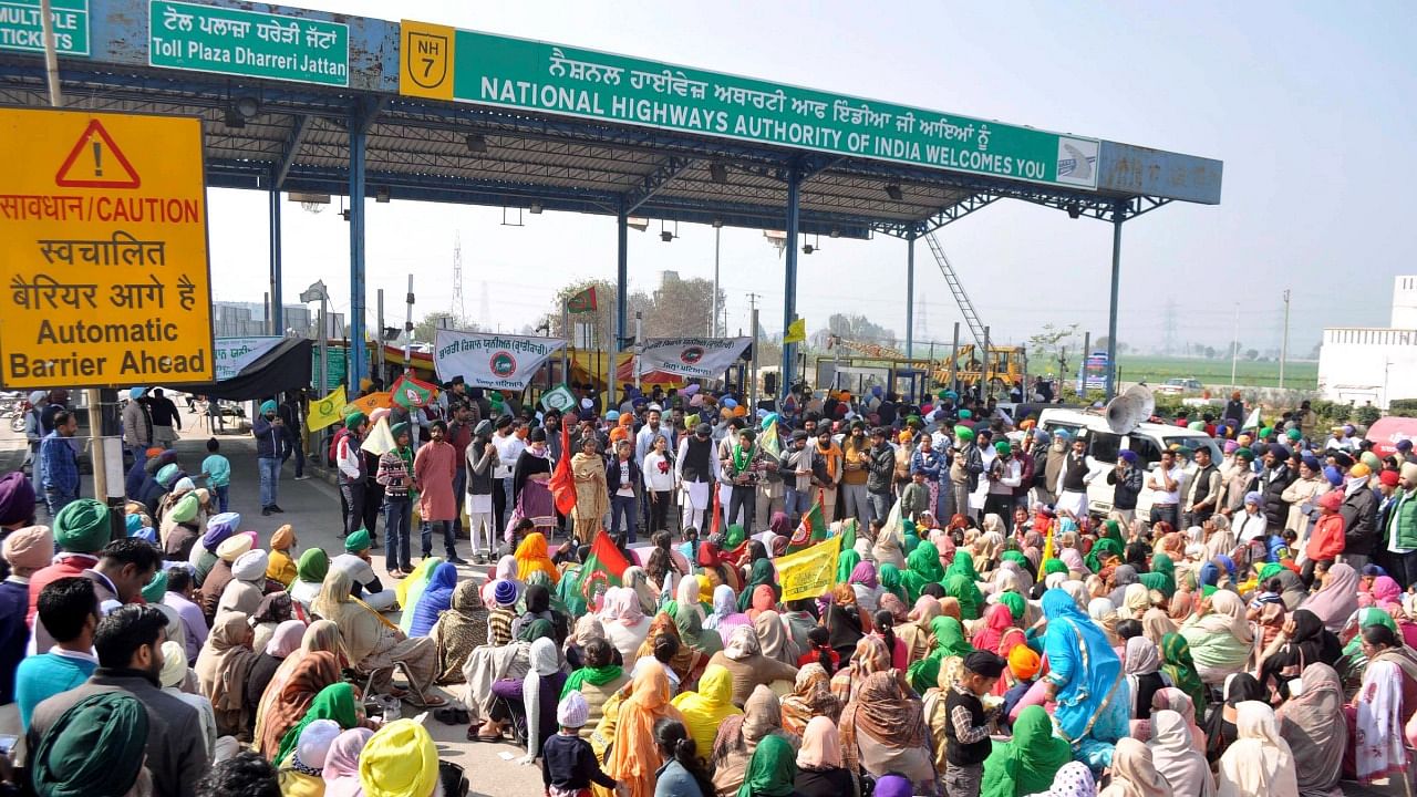 Members of various farmers organisations block the Dhareri Jattan Toll Plaza during their 'chakka jam, protest against the new farm laws, in Patiala, Saturday, February 6, 2021. Credit: PTI Photo