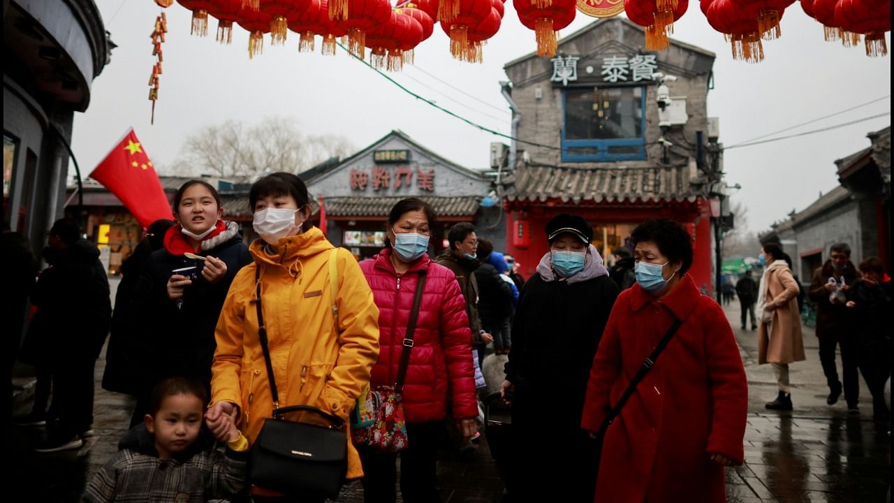 People walk in a historic part of Beijing as China celebrates Lunar New Year of the Ox following an outbreak of the coronavirus disease. Credit: Reuters Photo