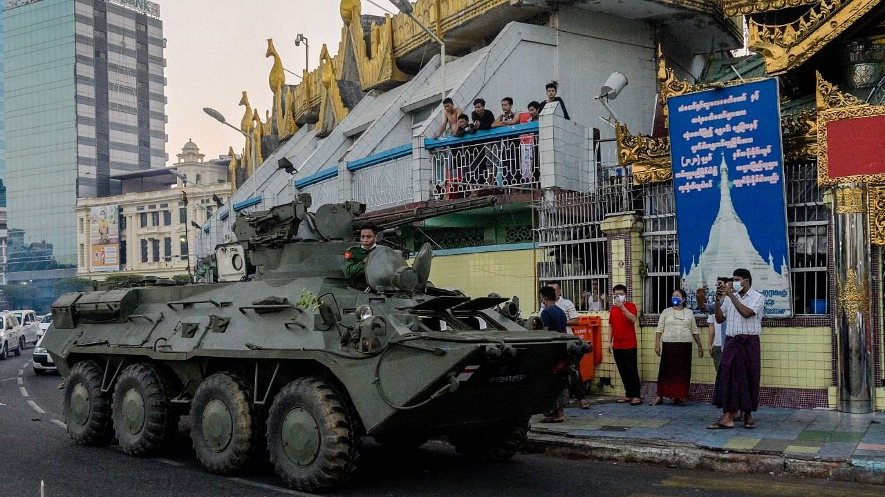 An armoured vehicle drives next to the Sule Pagoda, following days of mass protests against the military coup, in Yangon on February 14, 2021. Credit: AFP Photo