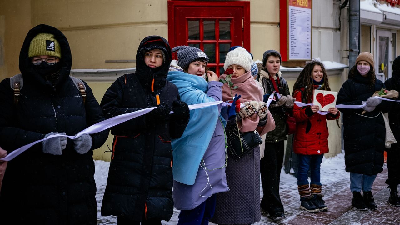 Russian women holding flowers and a long white ribbon form a human chain using Valentine's Day to express support for the wife of jailed opposition leader and political prisoners, on Arbat Street in Moscow's historic city centre. Credit: AFP Photo.