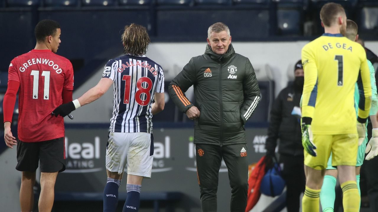 Manchester United's Norwegian manager Ole Gunnar Solskjaer (C) greets the players at the end of the English Premier League football match between West Bromwich Albion and Manchester United at The Hawthorns stadium in West Bromwich, central England, on February 14, 2021. Credit: AFP Photo