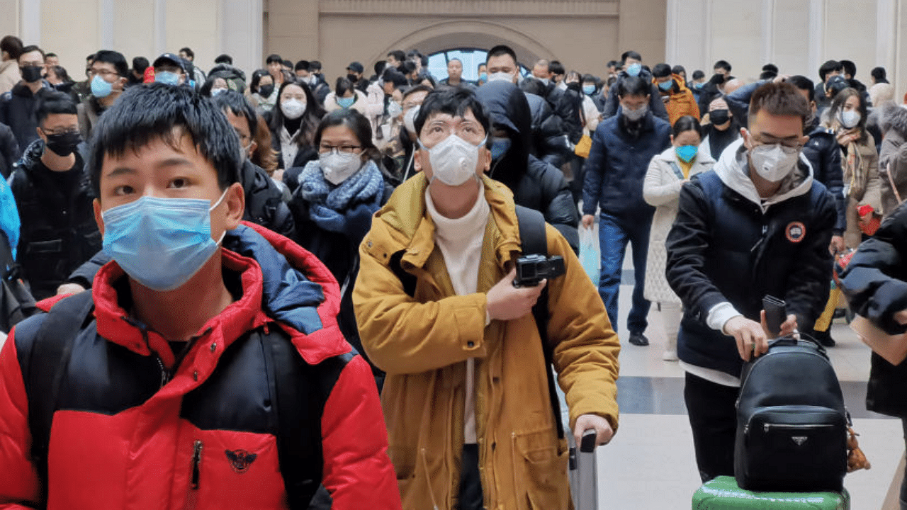 People wear face masks as they wait at Hankou Railway Station on January 22, 2020 in Wuhan, China. Credit: Getty Images