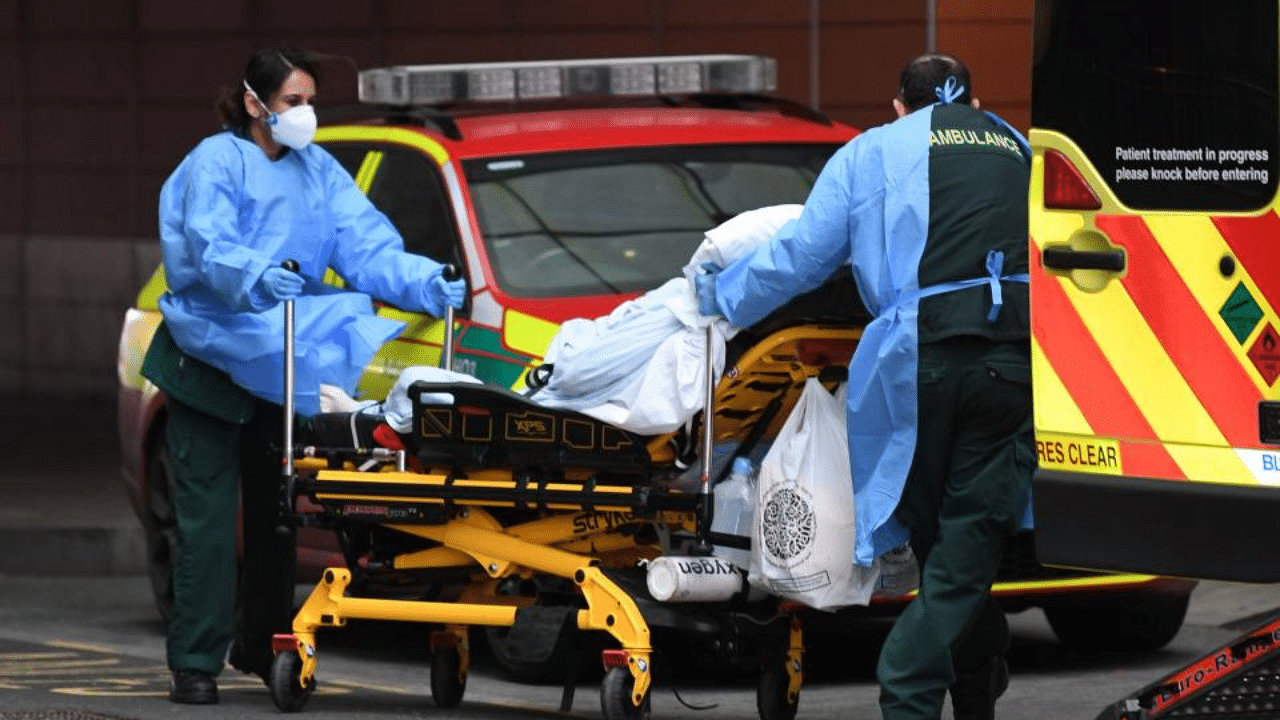 Paramedics wheel a patient from an ambulance into the Royal London Hospital in east London on January 21, 2021. Credit: AFP Photo