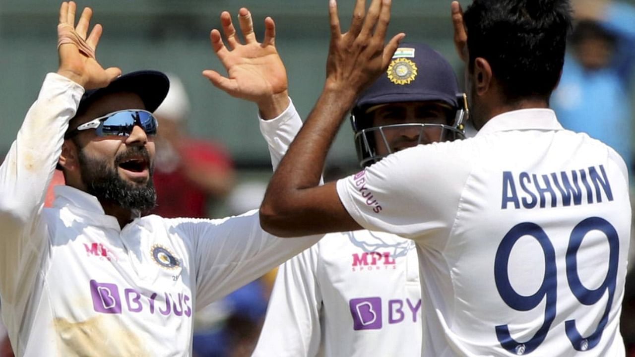 India's spinner Ravichandran Ashwin celebrates with Virat Kohli the wicket of England's Ben Stokes during the 2nd day of second cricket test match between India and England, at M.A. Chidambaram Stadium, in Chennai, Sunday. Credit: PTI Photo