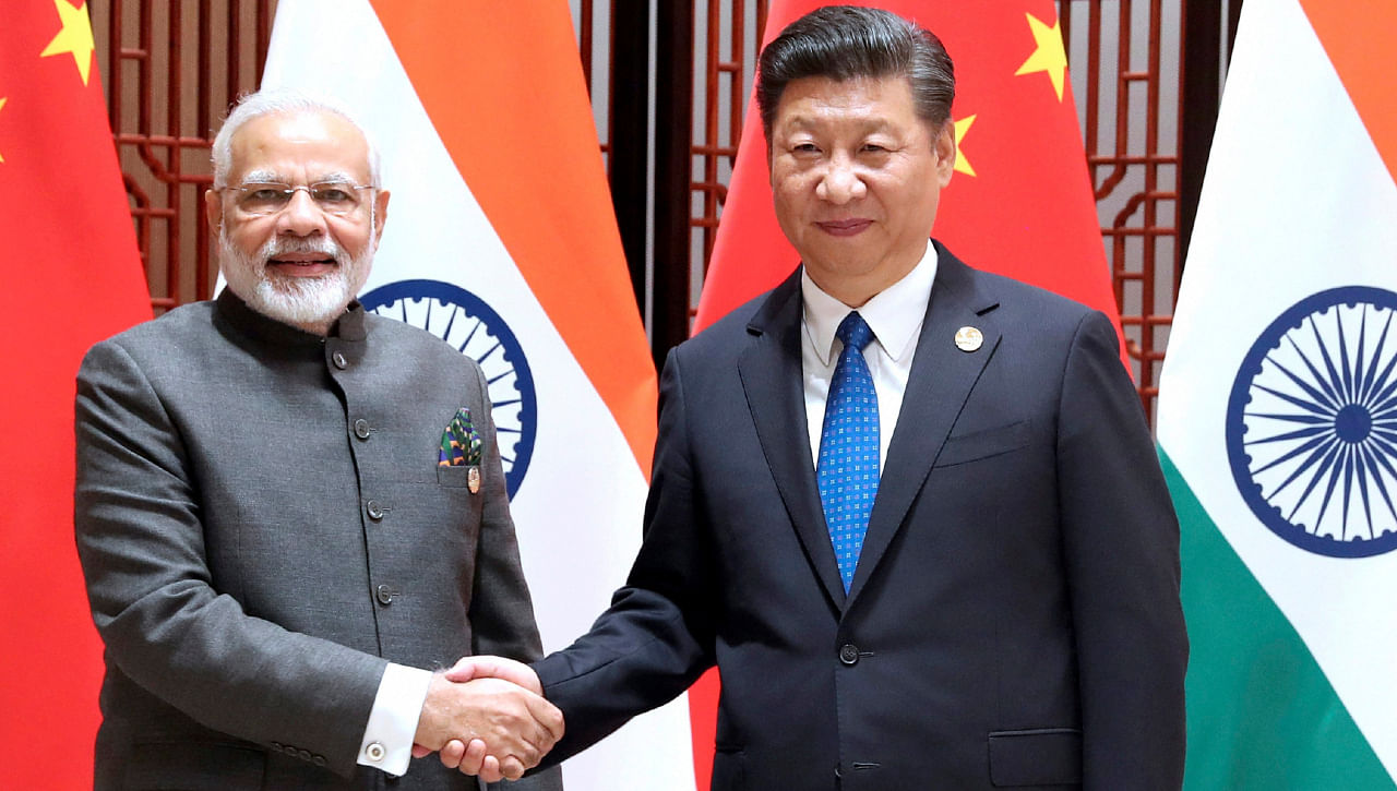 Prime Minister Narendra Modi, left, and China's President Xi Jinping shake hands as they pose for a photo during a meeting on the sidelines of the BRICS Summit in Xiamen in southeastern China's Fujian Province, Tuesday, Sept. 5, 2017. India's foreign secretary says the leaders of China and India have emphasized that peace and tranquility in their border areas is a "prerequisite" for the further development of their relationship. Credit: China's Xinhua News Agency via AP/PTI File Photo