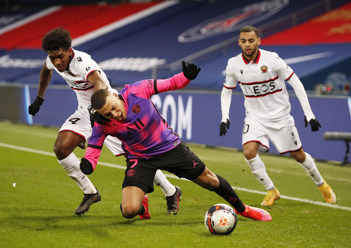 Paris St Germain's Kylian Mbappe in action with OGC Nice's Andy Pelmard and Alexis Claude-Maurice. Credit: Reuters photo. 