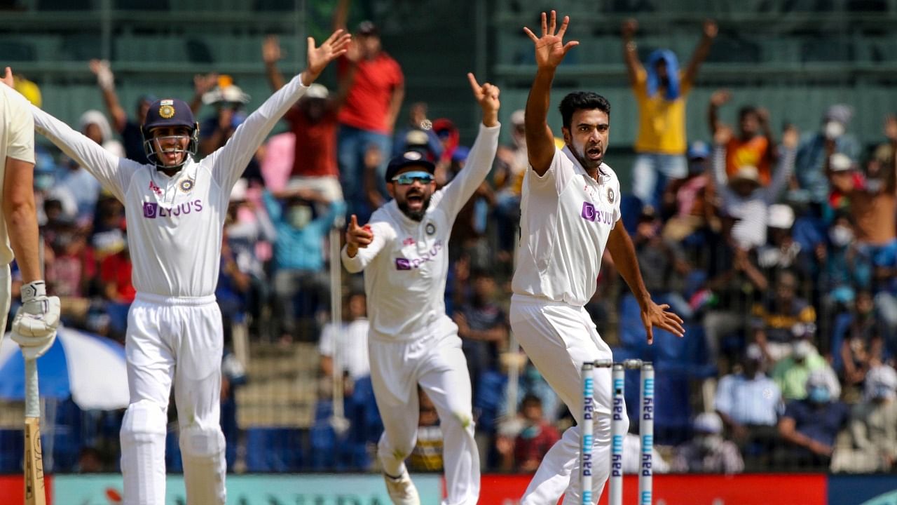 India's spinner Ravichandran Ashwin celebrates with teammates the wicket of England's Dom Sibley during the 2nd day of second cricket test match between India and England, at M A Chidambaram Stadium, in Chennai. Credit: PTI Photo.