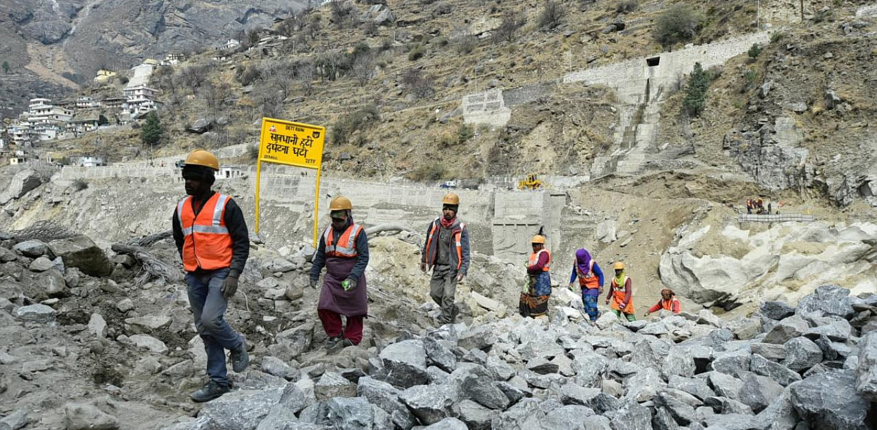 Locals on contract assist in rescue and restoration work at Raini village, after a glacier burst on Feb. 7 in Joshimath triggered a flash flood, in Chamoli district of Uttarakhand. Credit: PTI photo. 
