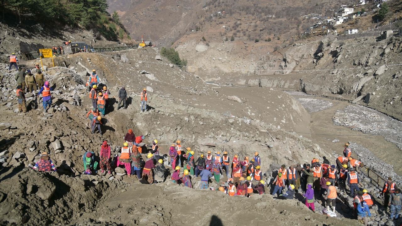 Border Roads Organisation (BRO) workers rebuild the destroyed Raini bridge in Chamoli district on February 13, 2021 after Raini bridge was washed away by a flash flood thought to have been caused when a glacier burst on February 7. Credit: AFP Photo