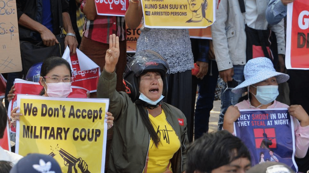 A protester (C) cries and holds up the three finger salute during a demonstration against the military coup in Naypyidaw on February 14, 2021. Credit: AFP Photo