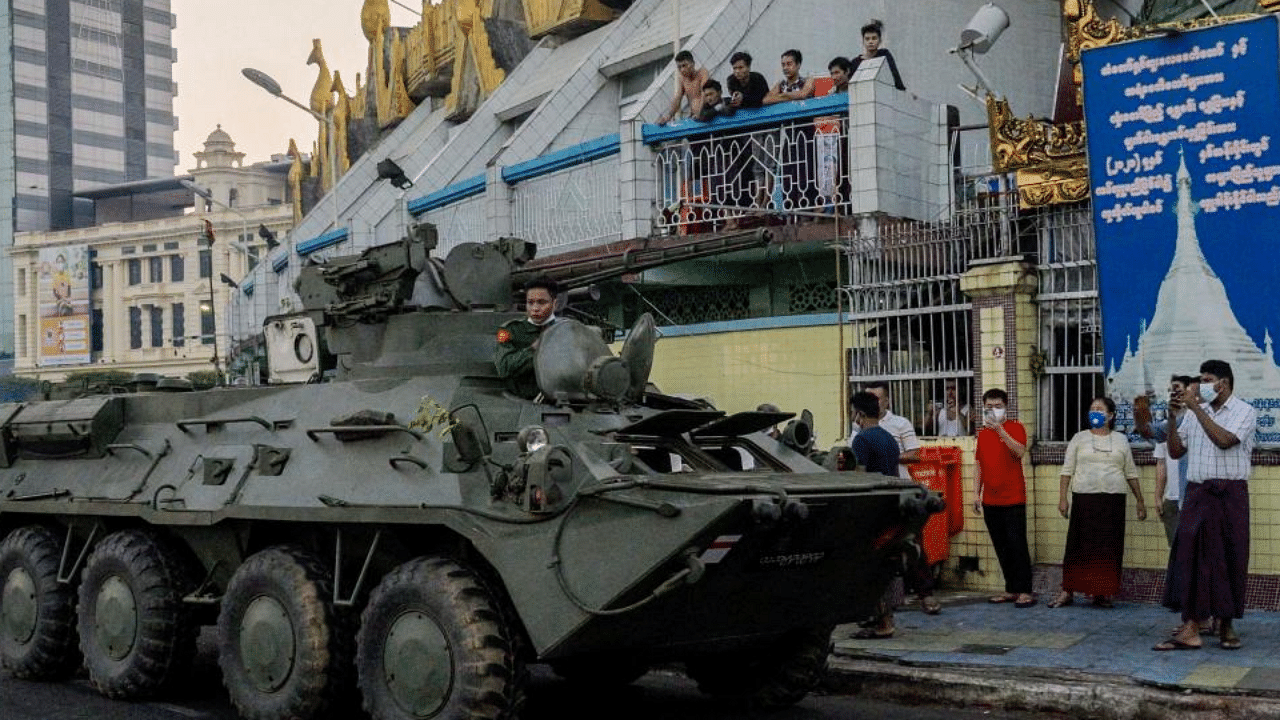 An armoured vehicle drives next to the Sule Pagoda, following days of mass protests against the military coup, in Yangon on February 14, 2021.  Credit: AFP Photo