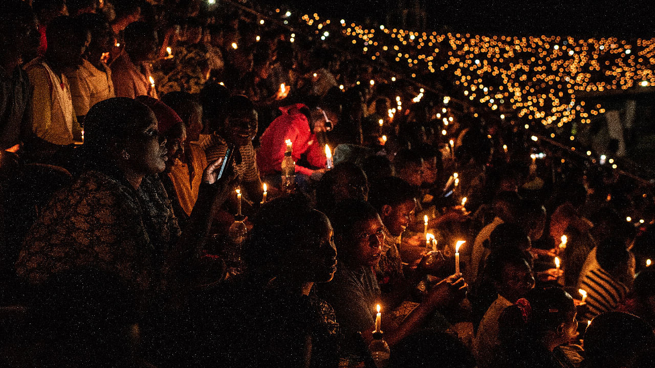 People hold candles during a commemoration ceremony of the 1994 genocide on April 7. Credit: Getty Images