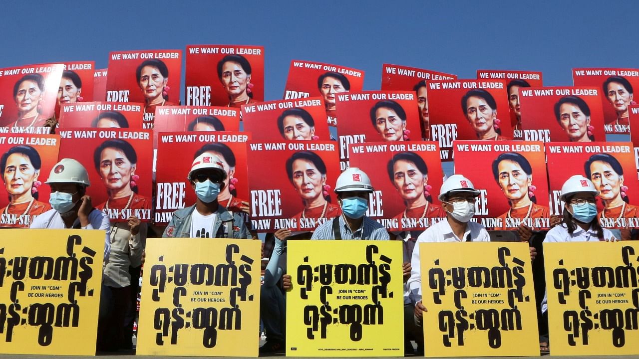 Demonstrators hold placards with the image of Aung San Suu Kyi during a protest against the military coup, in Nay Pyi Taw, Myanmar. Credit: Reuters Photo