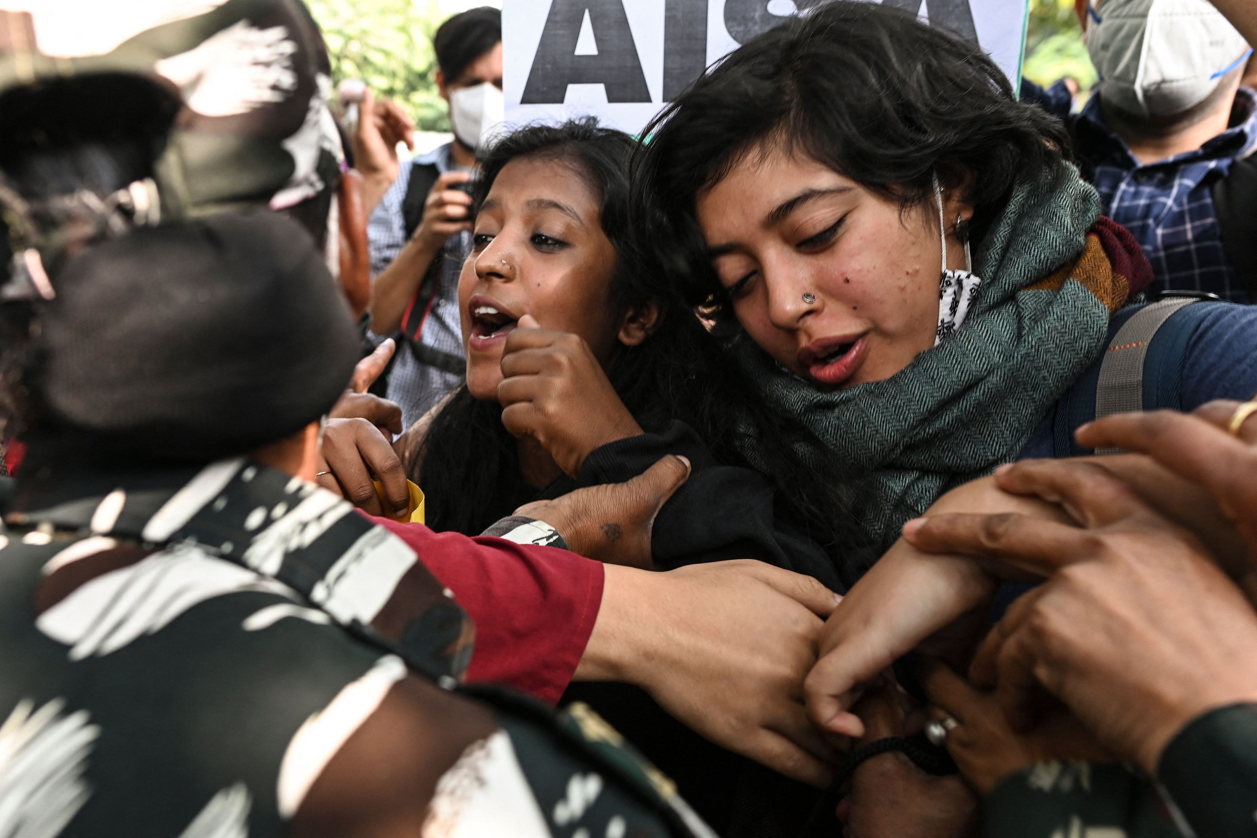 Police personnel stop demonstrators as they try to cross police barricades during a protest against the arrest of climate change activist Disha Ravi by Delhi police for allegedly helping to create a guide for anti-government farmers protests shared by environmentalist Greta Thunberg, outside the Delhi Police headquarters, in New Delhi on February 16, 2021. Credit: AFP Photo