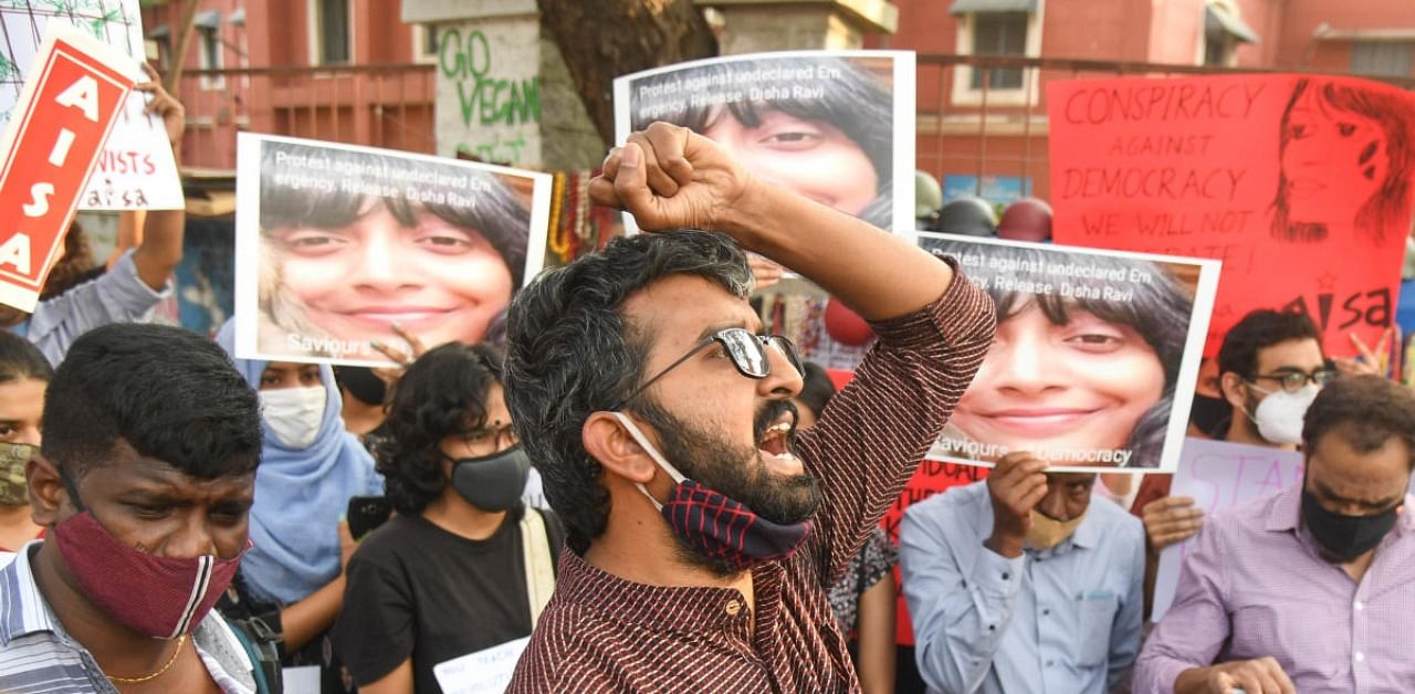 Members of various social organisations display placards during a protest against the arrest of climate activist Disha Ravi, in Bengaluru on Monday. Credit: DH Photo/B H Shivakumar