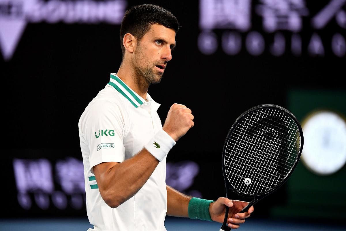 Serbia's Novak Djokovic reacts on a point against Canada's Milos Raonic during their men's singles match on day seven of the Australian Open tennis tournament in Melbourne. Credit: AFP photo. 