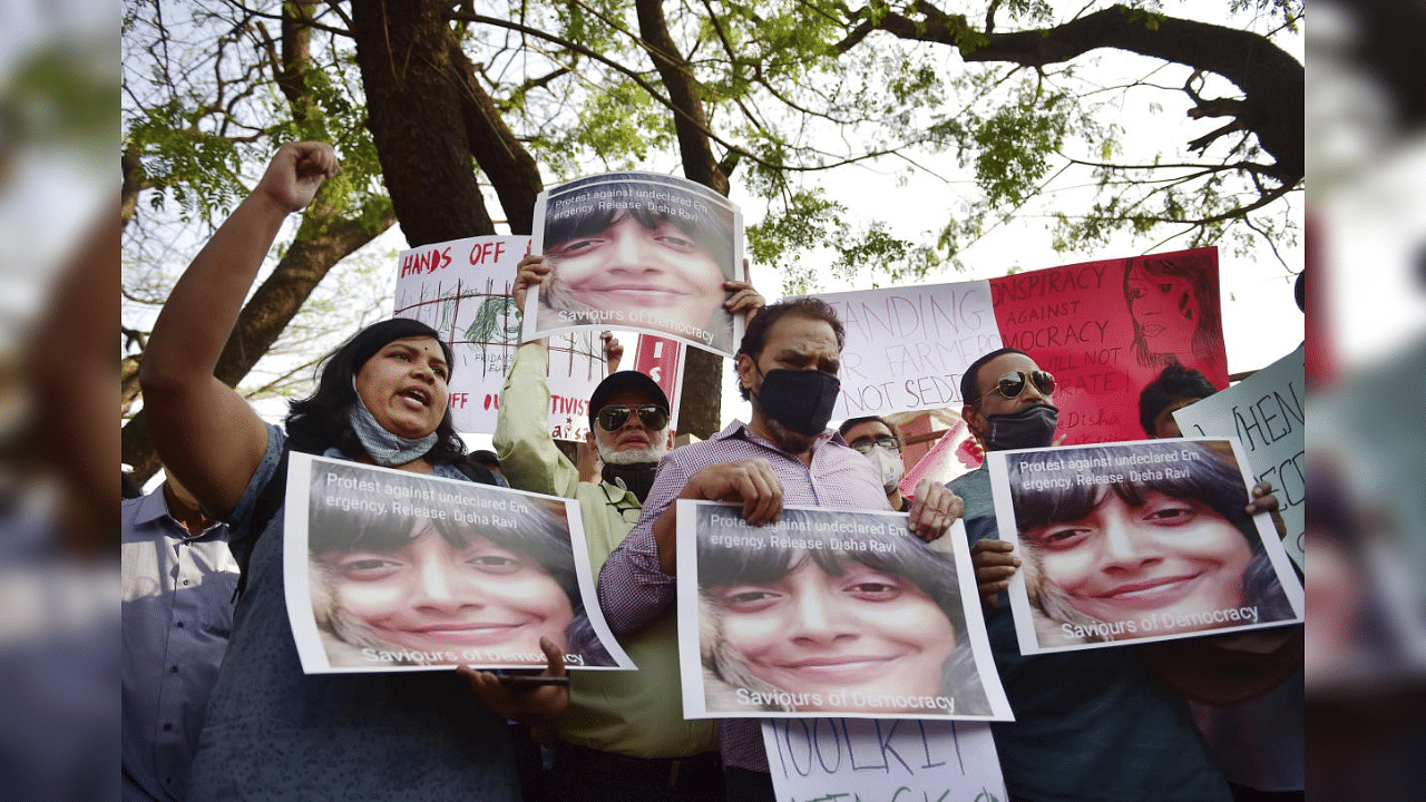  Members of various social organisation display placards during a protest against the arrest of climate activist Disha Ravi, in Bengaluru, Monday, Feb. 15, 2021. Disha A. Ravi was arrested on Saturday by the Delhi Police in connection with the Greta Thunberg's 'toolkit' case. Credit: PTI Photo