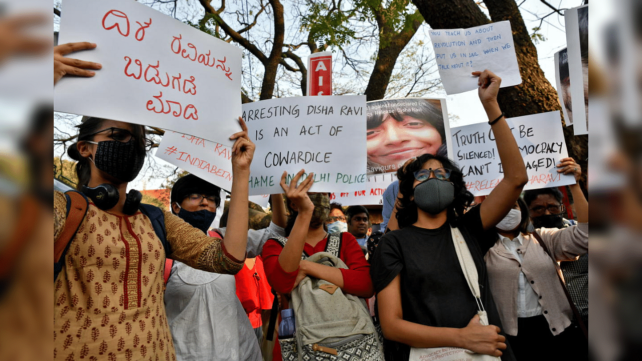 People hold placards during a protest against the arrest of 22-year-old climate activist Disha Ravi, in Bengaluru, India, February 15, 2021. Credit: Reuters Photo