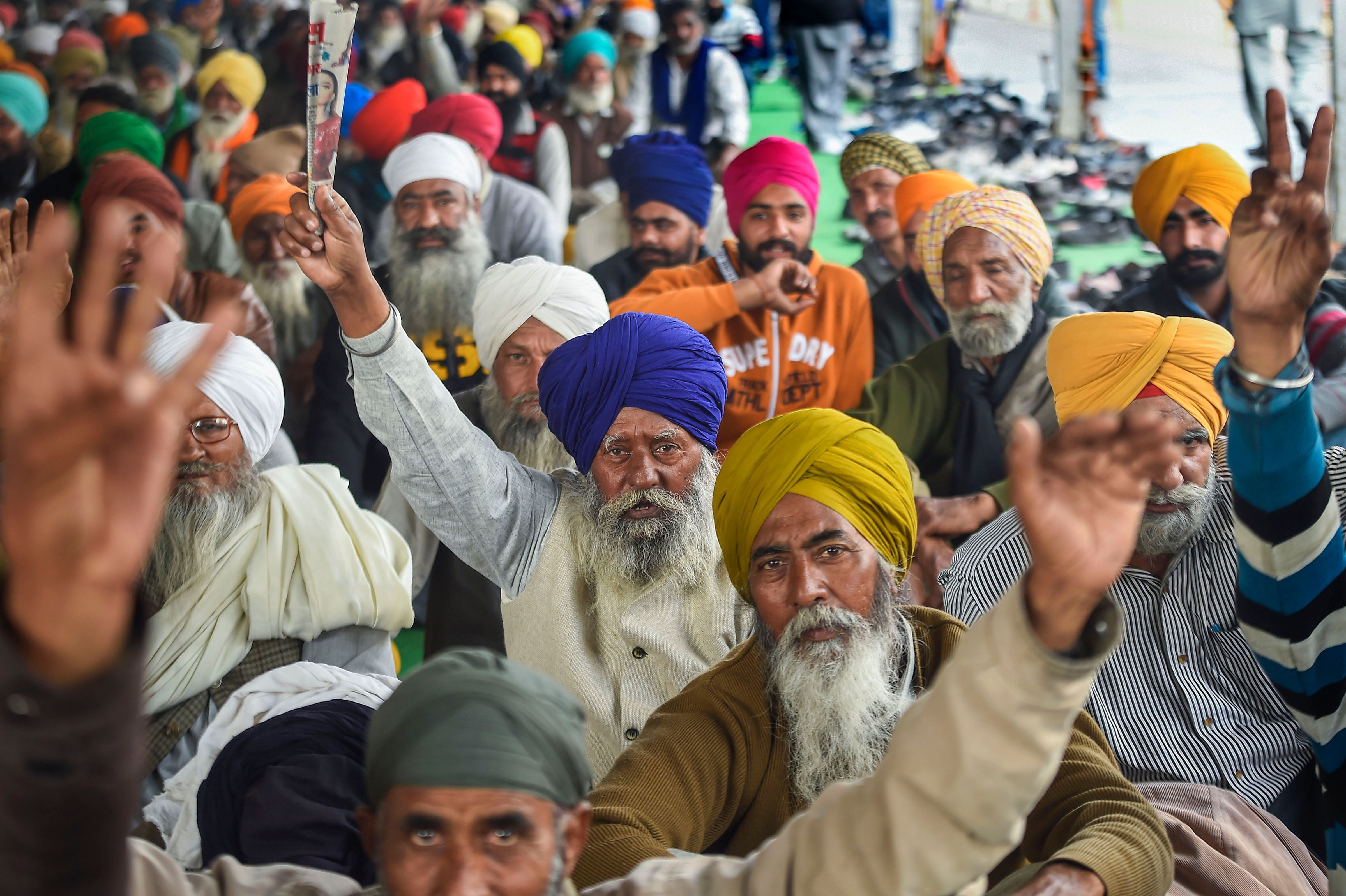 Farmers raise slogans during their ongoing protest against farm laws, at Singhu border in New Delhi, Thursday, Feb. 4, 2021. Credit: PTI Photo