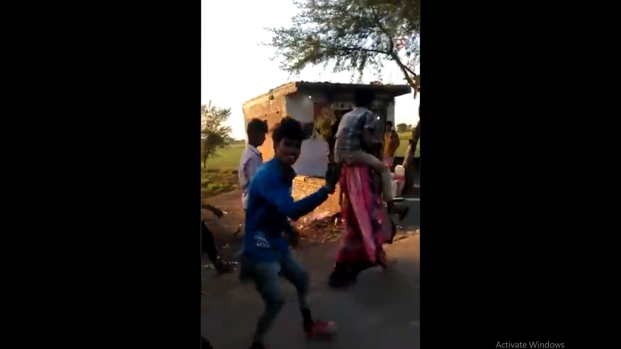 A tribal woman from MP was made to carry her ex-husband's relative on her shoulders, while her in-laws enjoyed her humiliation. Credit: Screengrab from Twitter
