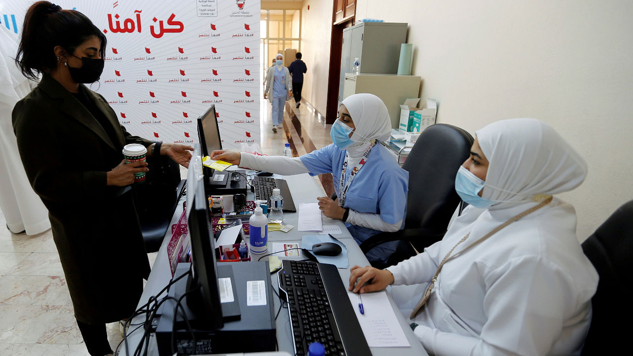 A woman takes her appointment for a second dose of a coronavirus disease. Credit: Reuters Photo
