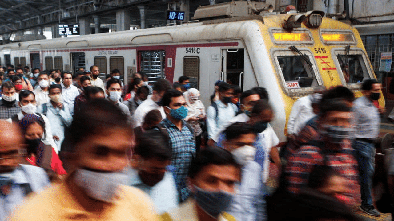 Commuters walk on a railway platform after disembarking from a train amidst the spread of the coronavirus disease (COVID-19) in Mumbai, India, February 9, 2021. Credit: Reuters Photo