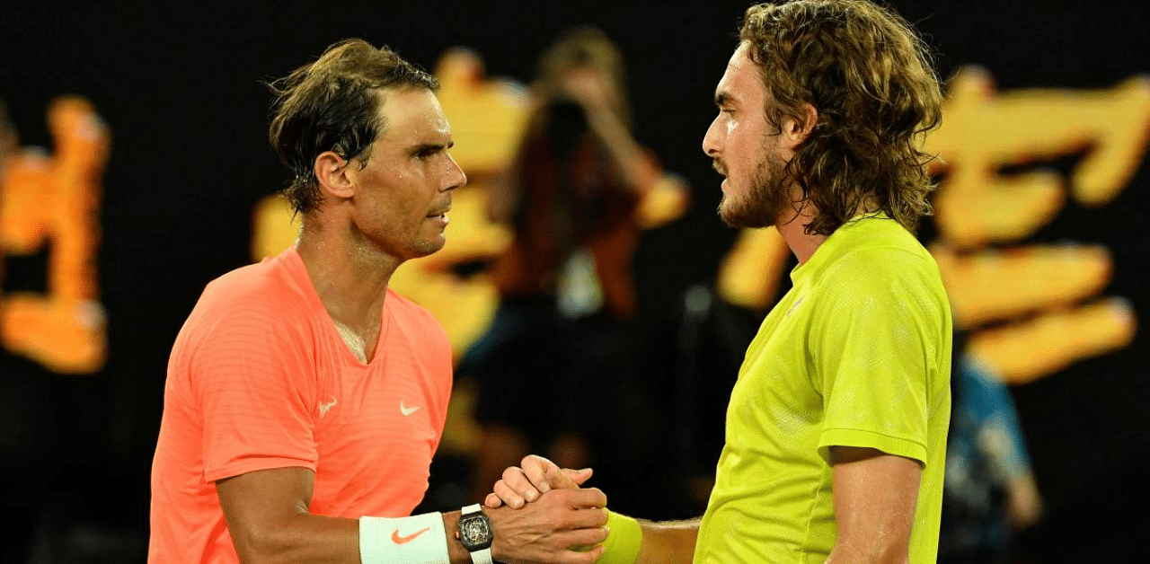 Greece's Stefanos Tsitsipas (R) and Spain's Rafael Nadal greet each other after their men's singles quarter-final match on day ten of the Australian Open tennis tournament in Melbourne. Credit: AFP Photo