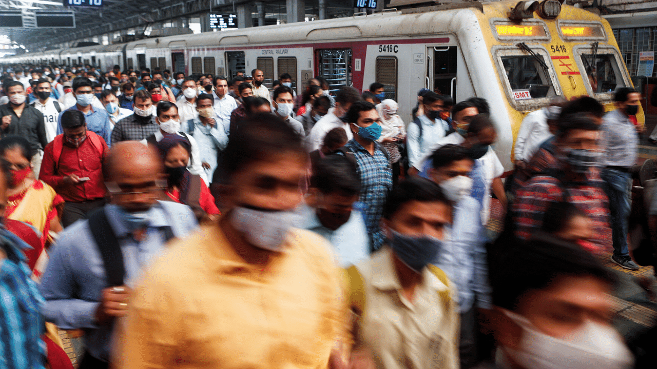Commuters walk on a railway platform after disembarking from a train amidst the spread of the coronavirus disease. Credit: Reuters Photo